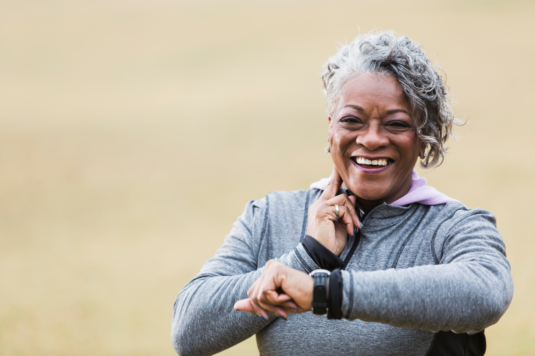Senior woman taking her own pulse while exercising